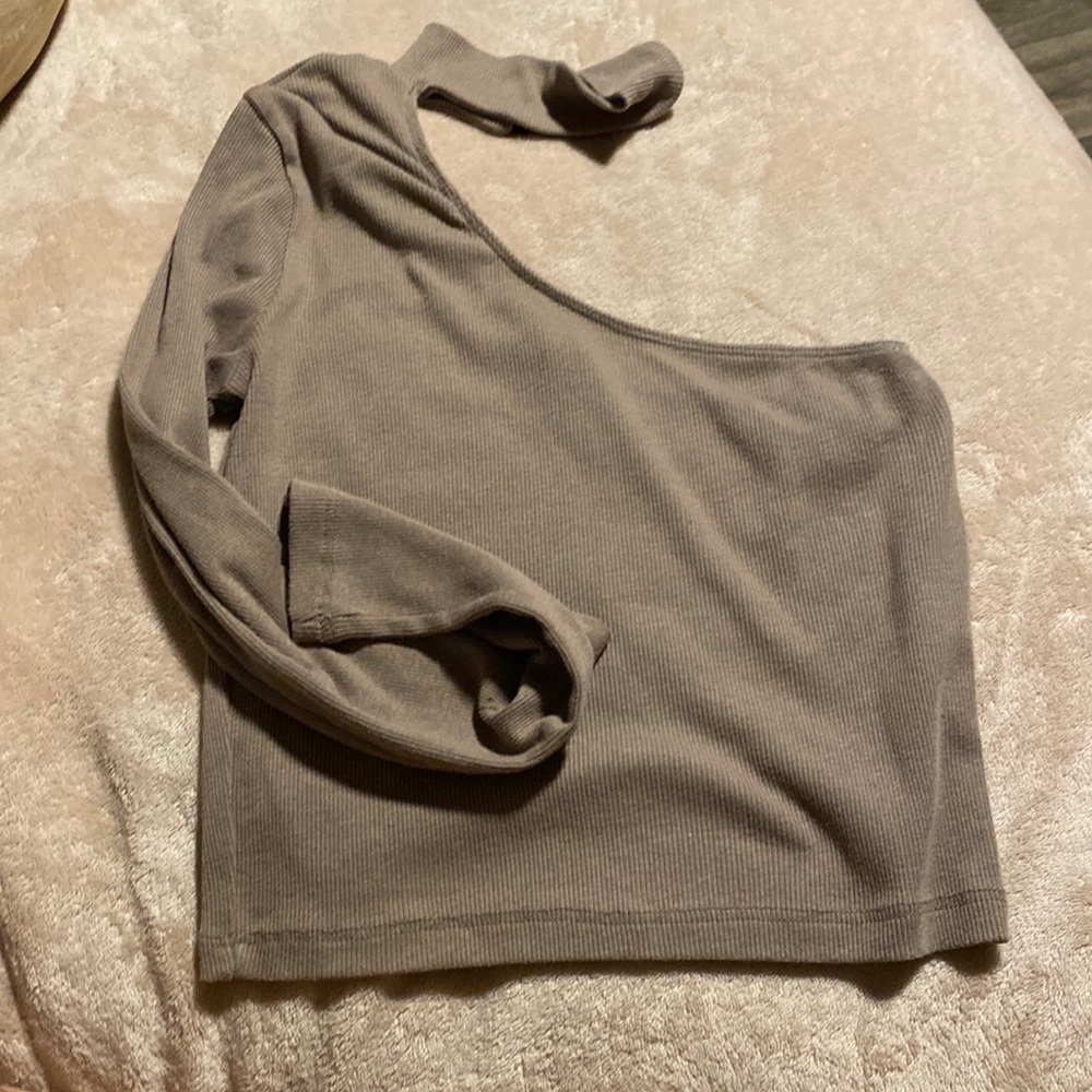 a brown one sleeve top with choker